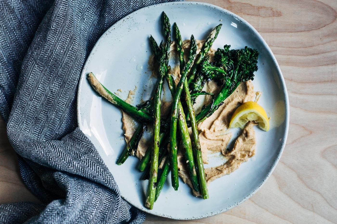 A serving of cauliflower puree with asparagus and broccolini