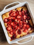 A baking dish with a just-baked strawberry spoon cake (aka strawberry cobbler).