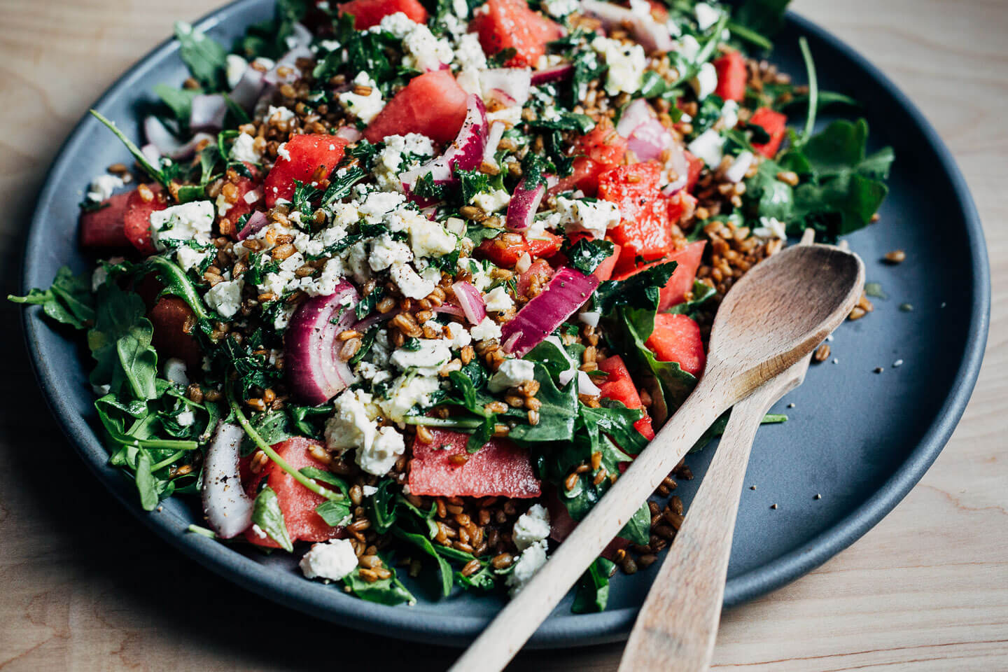 A big platter of watermelon feta salad with fried farro and fresh mint.
