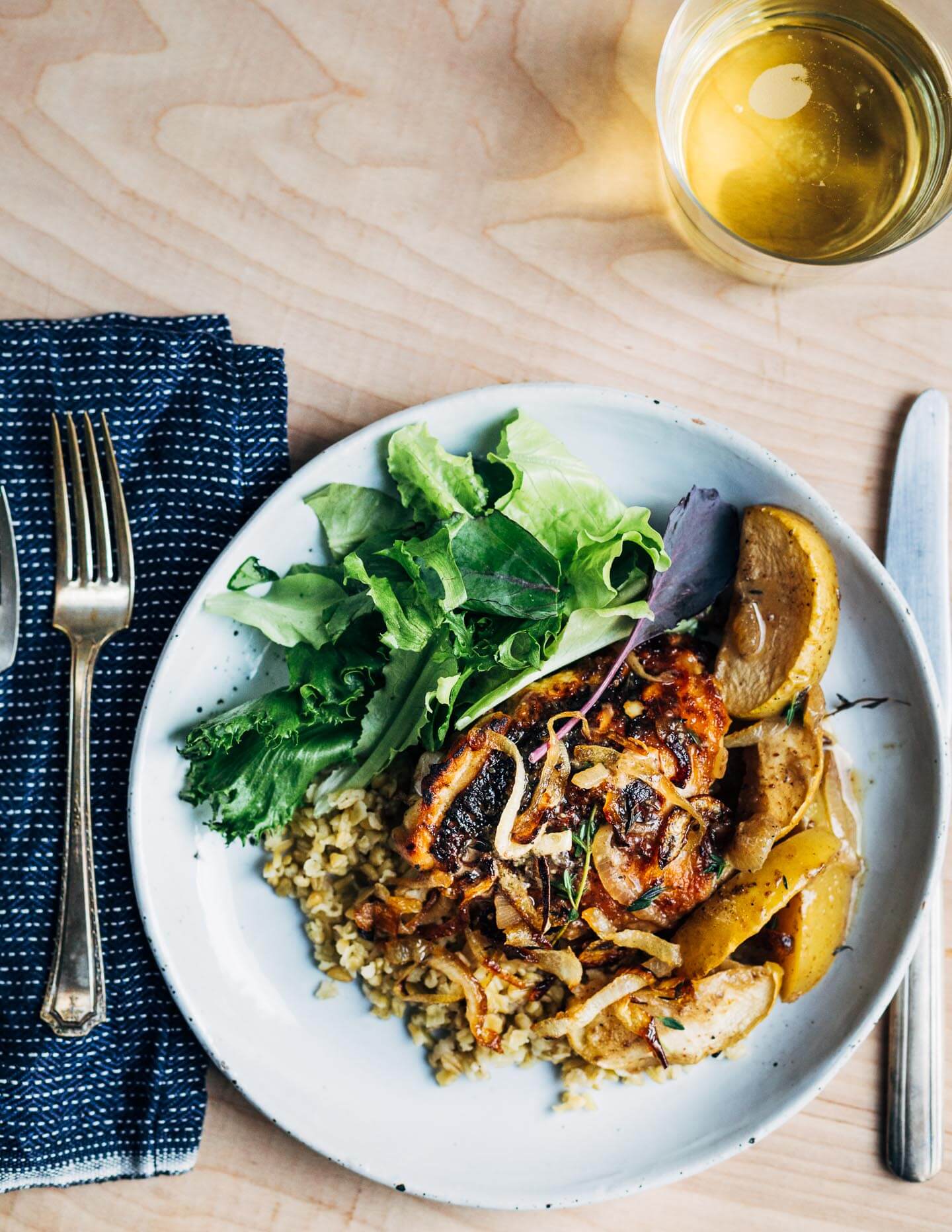 Cider-braised chicken thighs with caramelized onions.