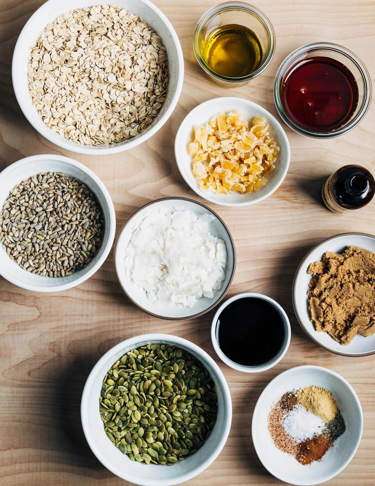 Gingerbread granola ingredients: oats, sunflower seeds, pumpkin seeds, ginger, spices, brown sugar, olive oil, maple syrup, and molasses