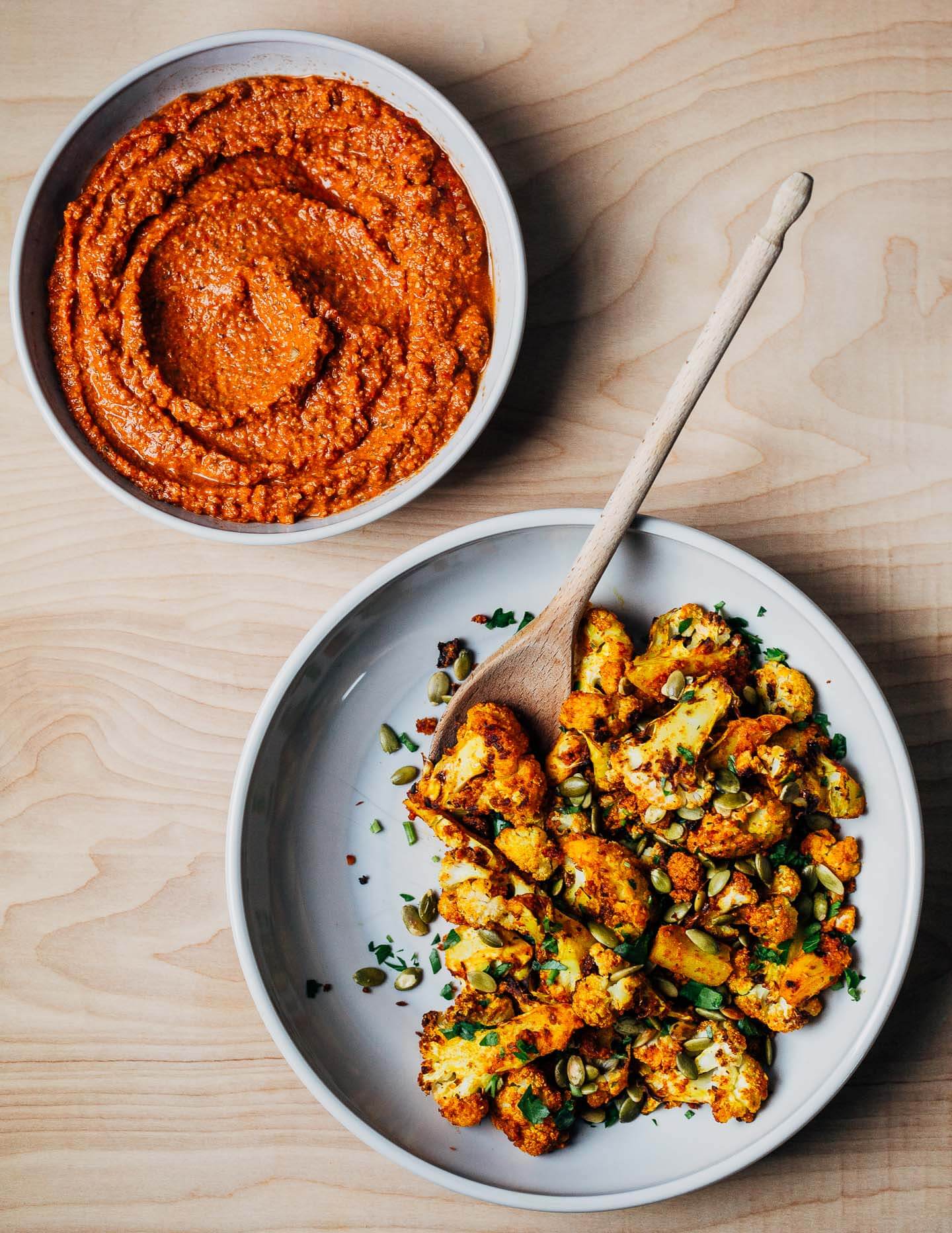 This recipe for romesco-roasted cauliflower coaxes bold, vibrant flavor out of that wintertime staple, roasted cauliflower, along with smoky depth from the romesco sauce and the crunch of salty pepitas.