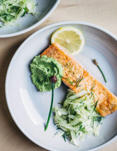 A plate of salmon with asparagus pesto