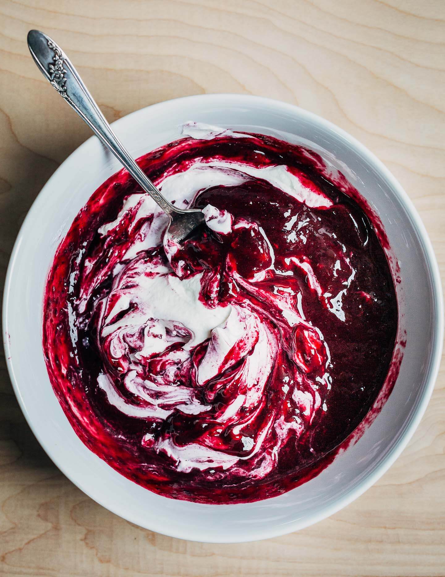A bowl with swirls and yogurt and blueberry puree
