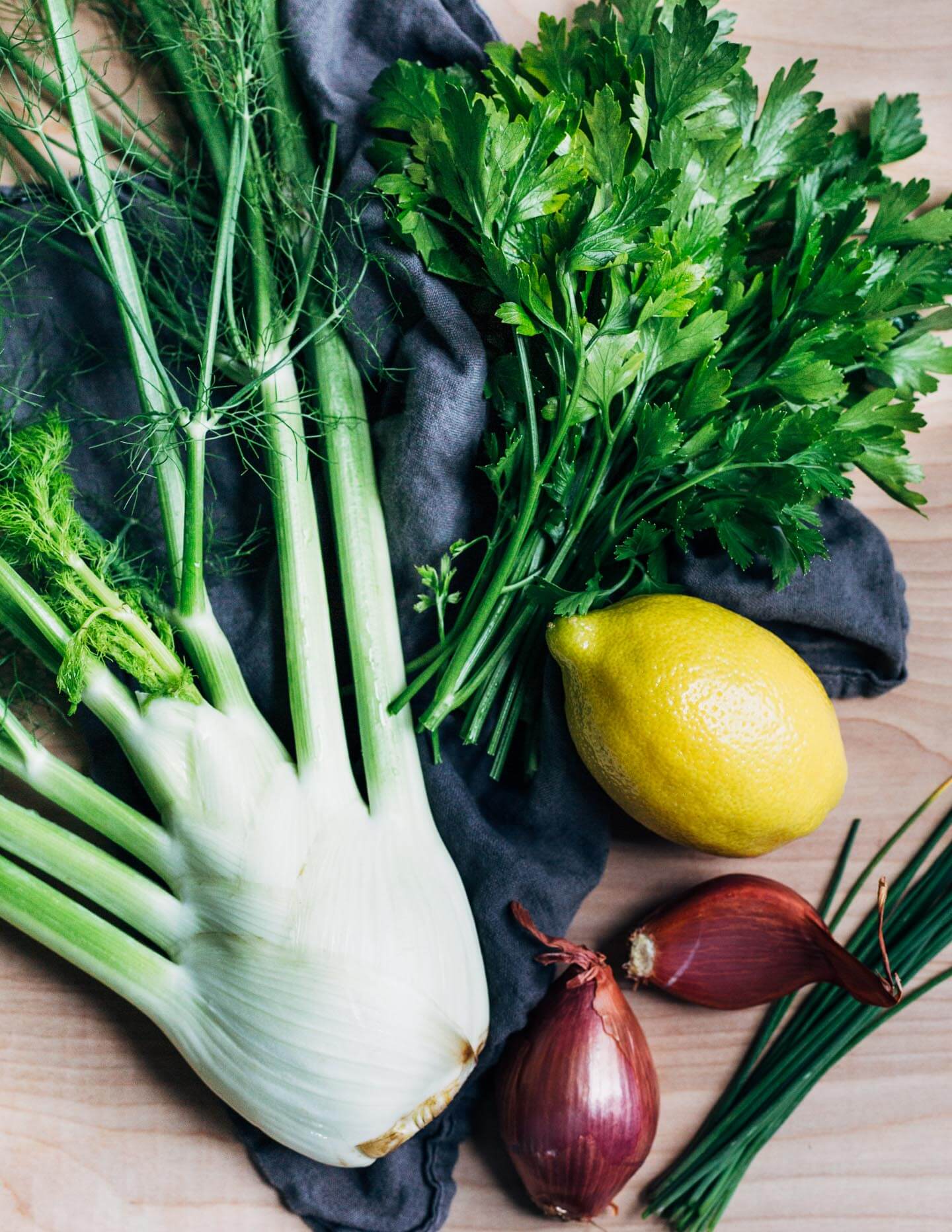 A fennel bulb, lemon, parsley and shallots.