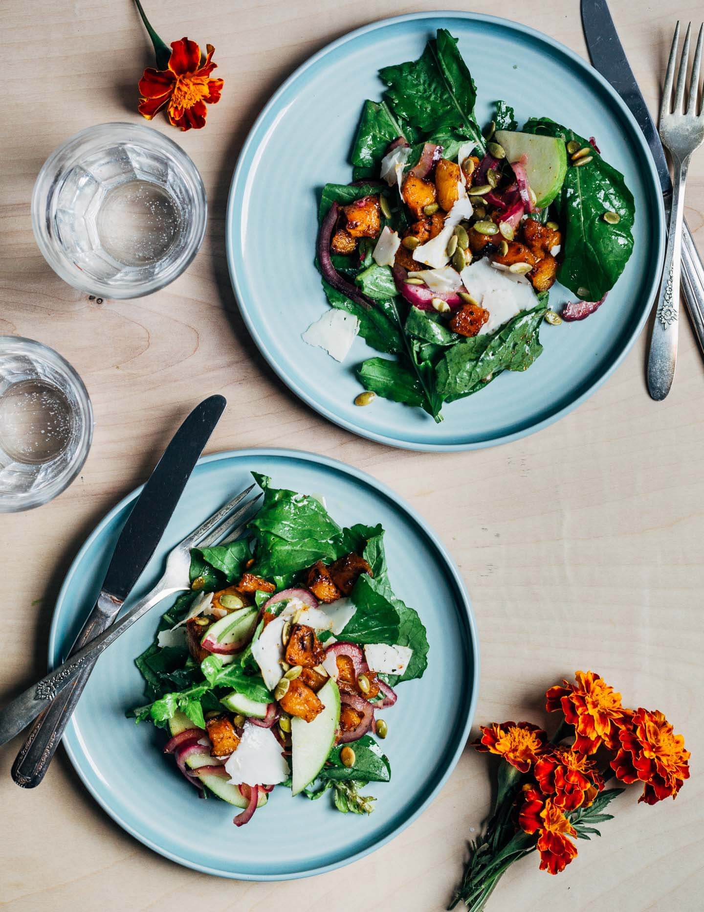 Two plates with salad on a table. 