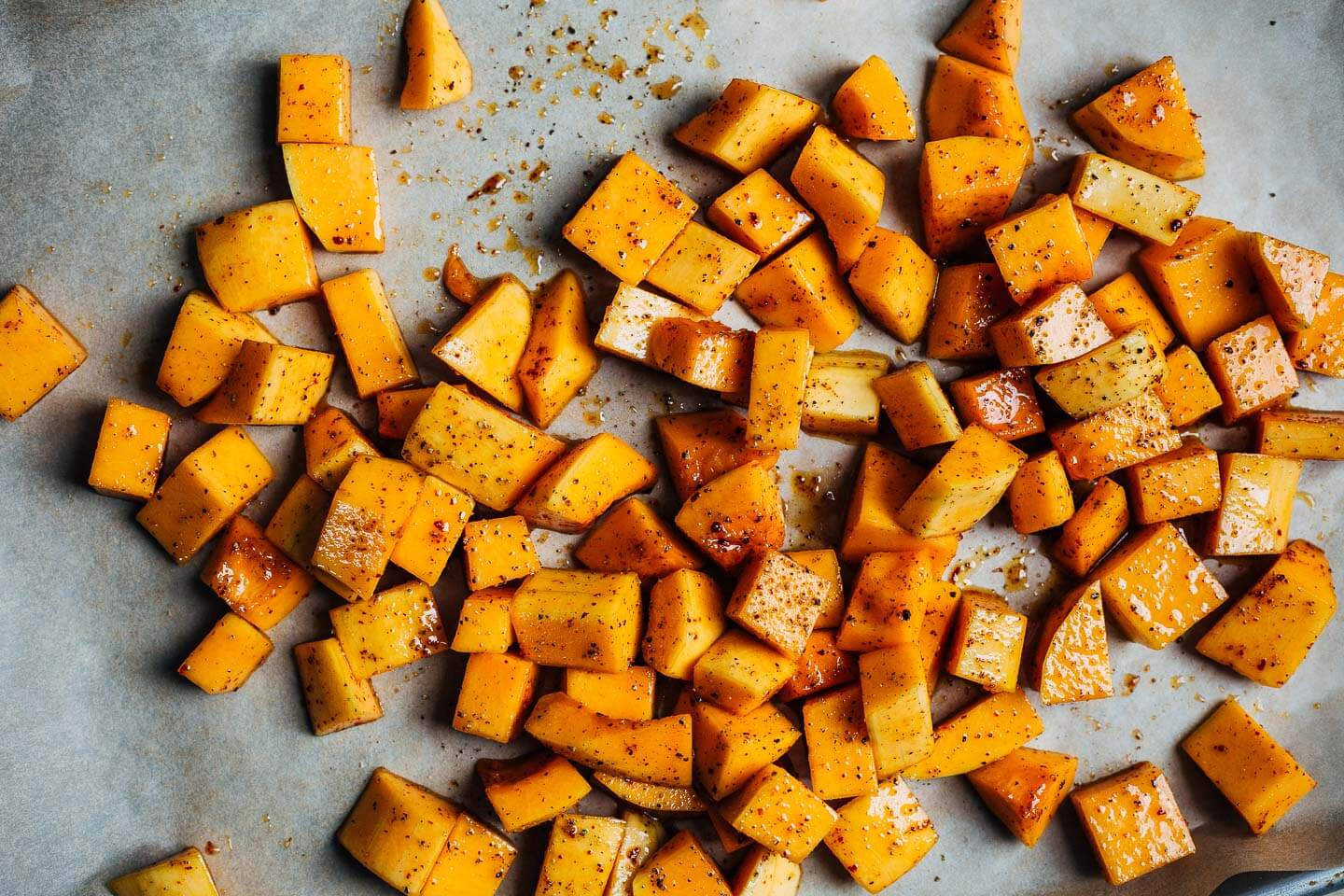 Cubed butternut squash on a baking sheet