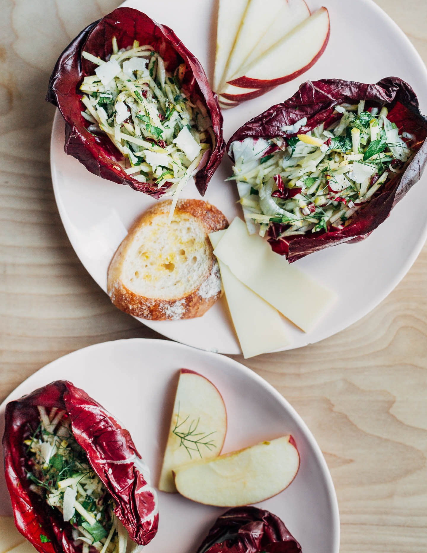 Serving plates with salad cups and other appetizers. 