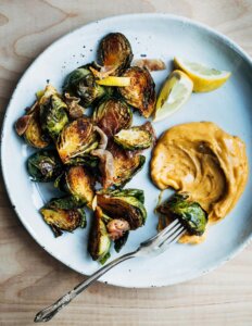 A plate of roasted Brussels sprouts with aioli.