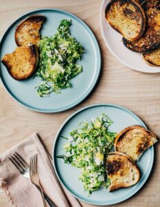 Plates with servings of salad and toasts alongside.