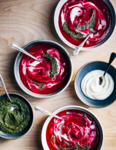 Bowls of vivid magenta beet soup.