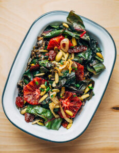 A little dish with a wild rice, chard, and blood ornage salad.