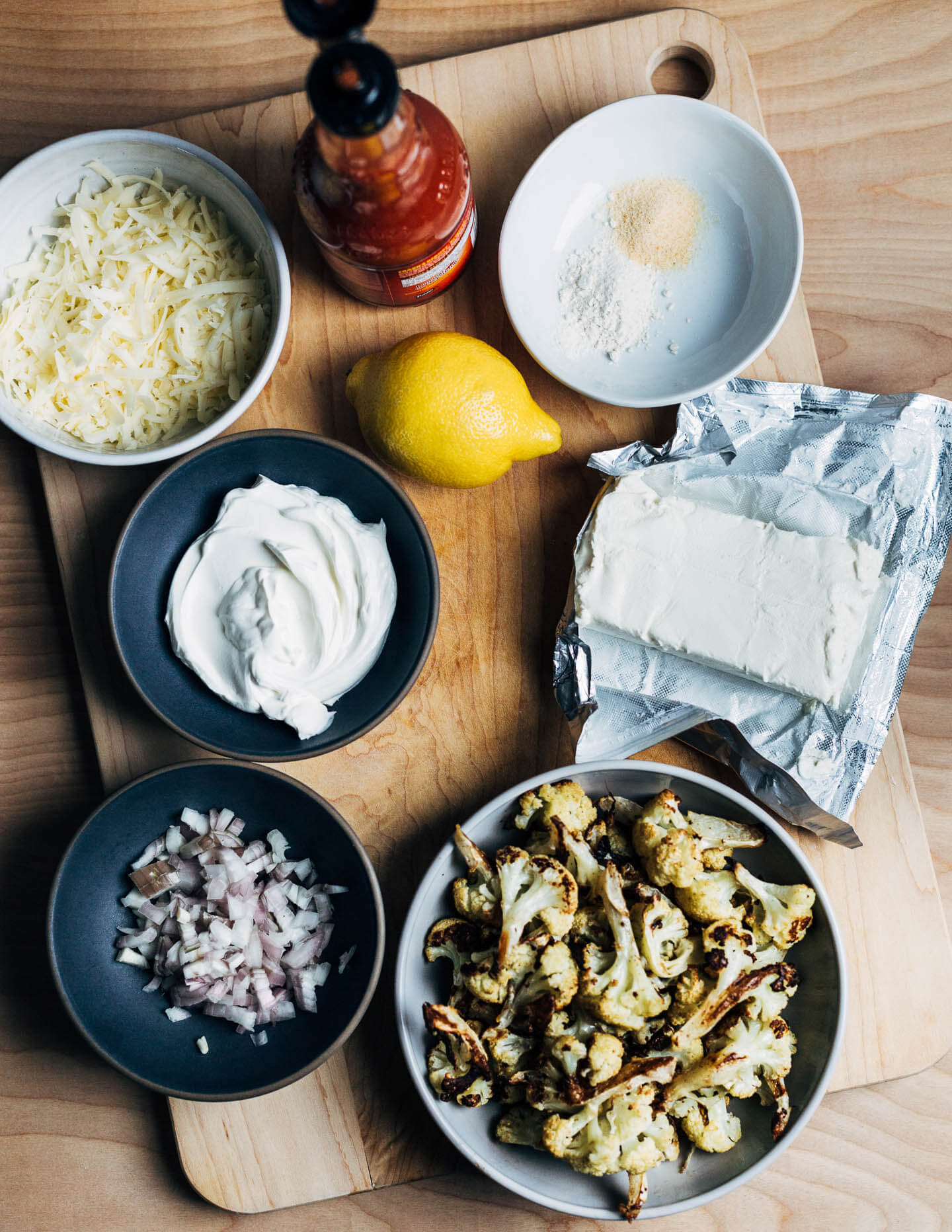 Ingredients for the Buffalo dip laid out on a cutting board. 