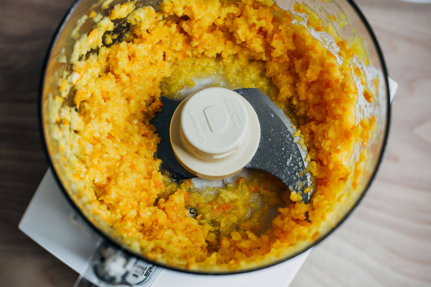 A food processor with orange pulp.