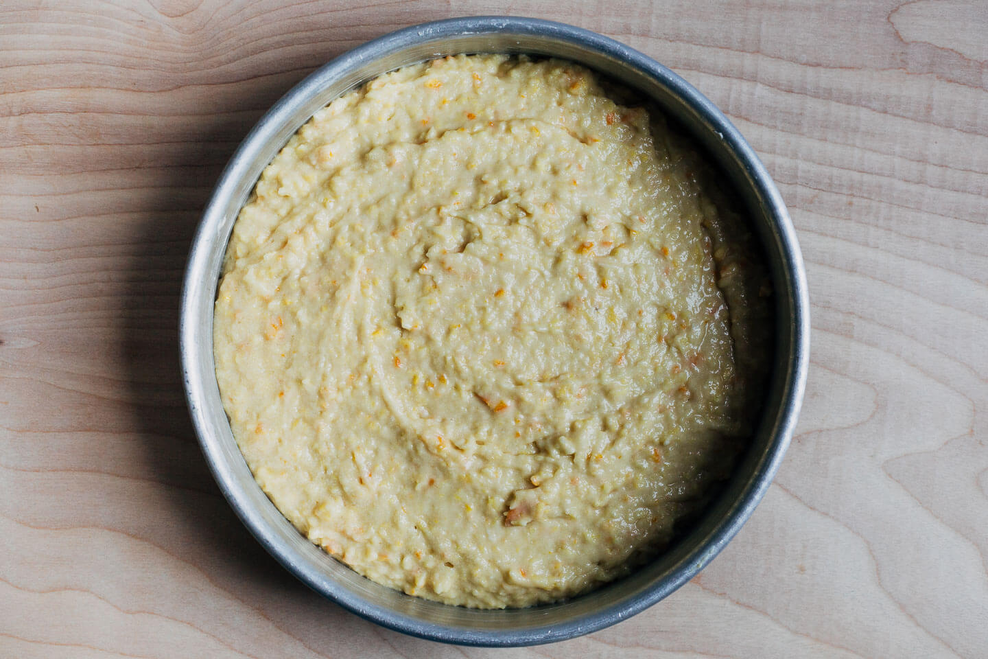 A cake pan filled with batter, ready to bake. 