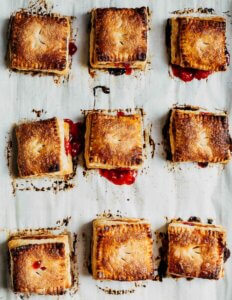 A baking sheet with several square handpies, just out of the oven.