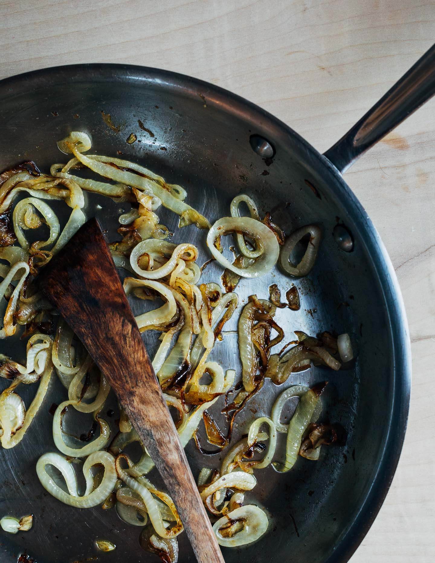 Onions caramelizing in a skillet. 