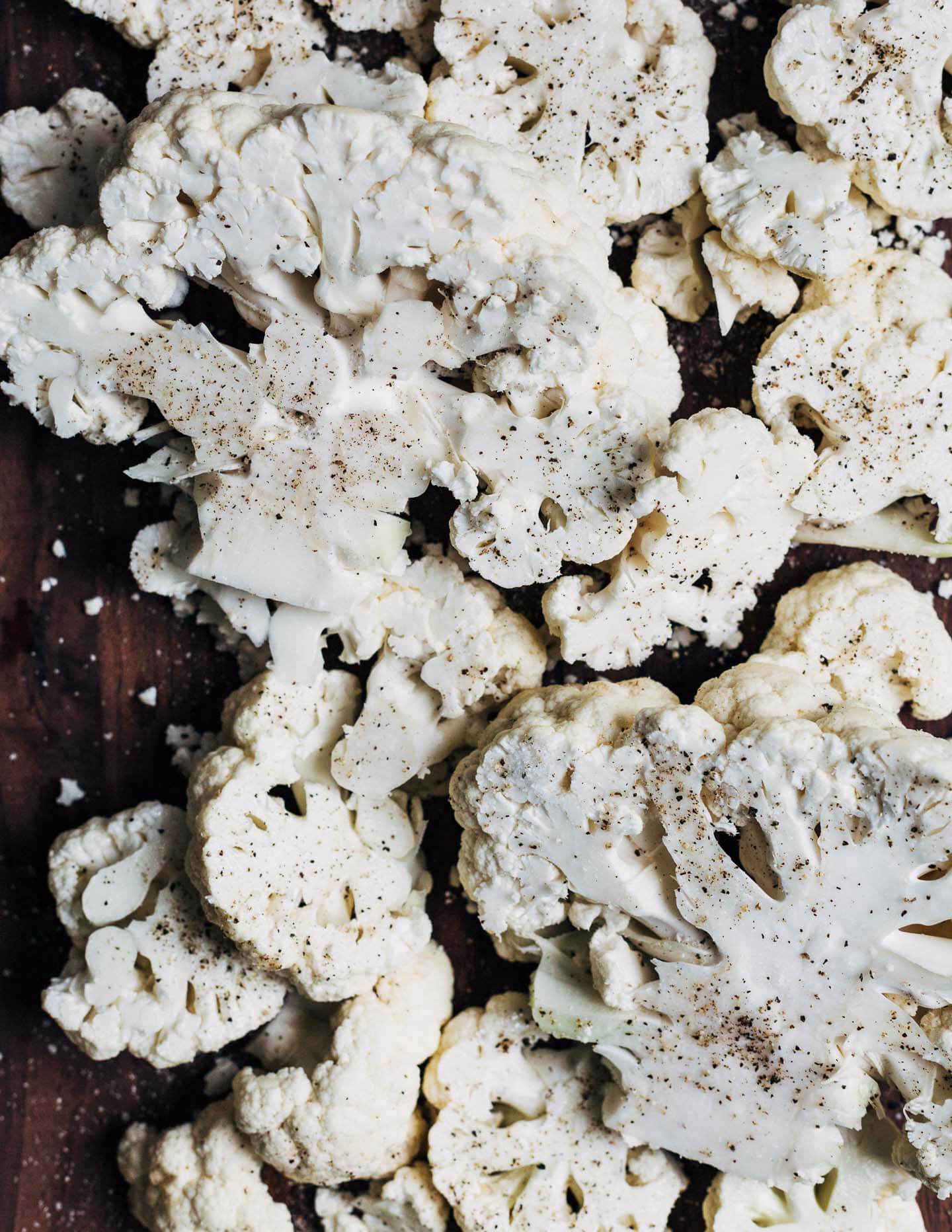 Sliced cauliflower on a cutting board. 