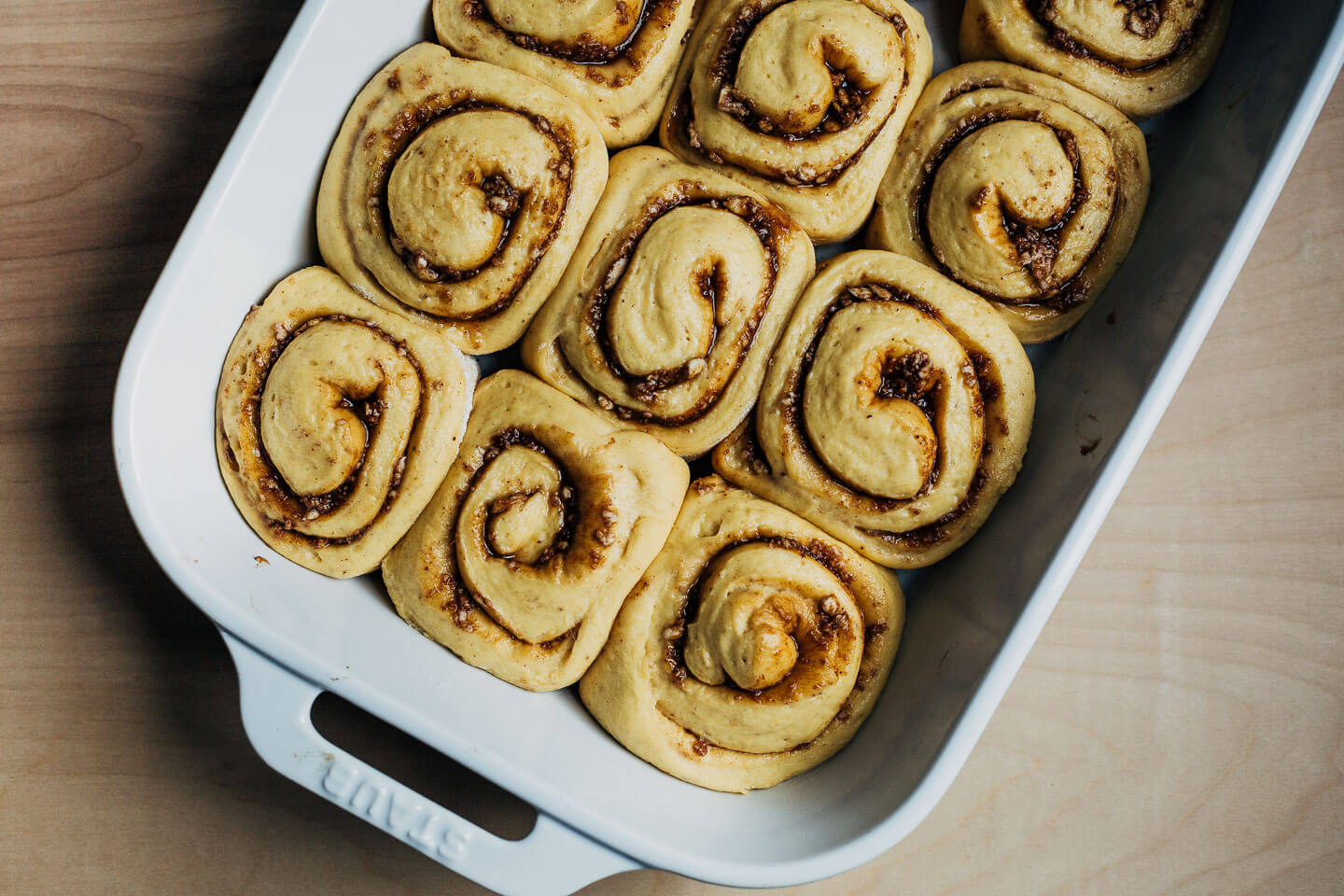 Cinnamon roll dough in a baking dish, ready to bake. 
