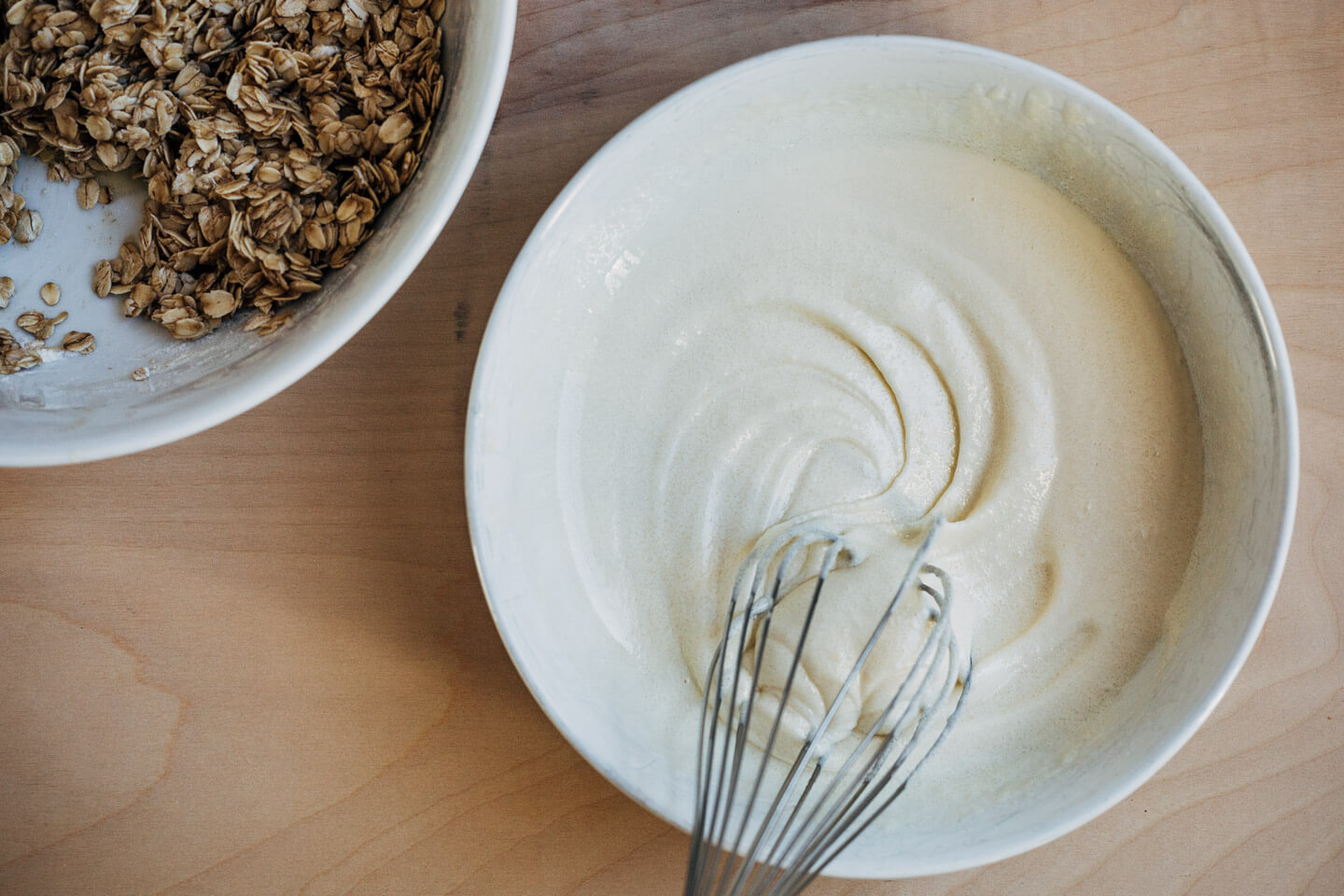A bowl with sugar and egg whisked until fluffy and pale white. 