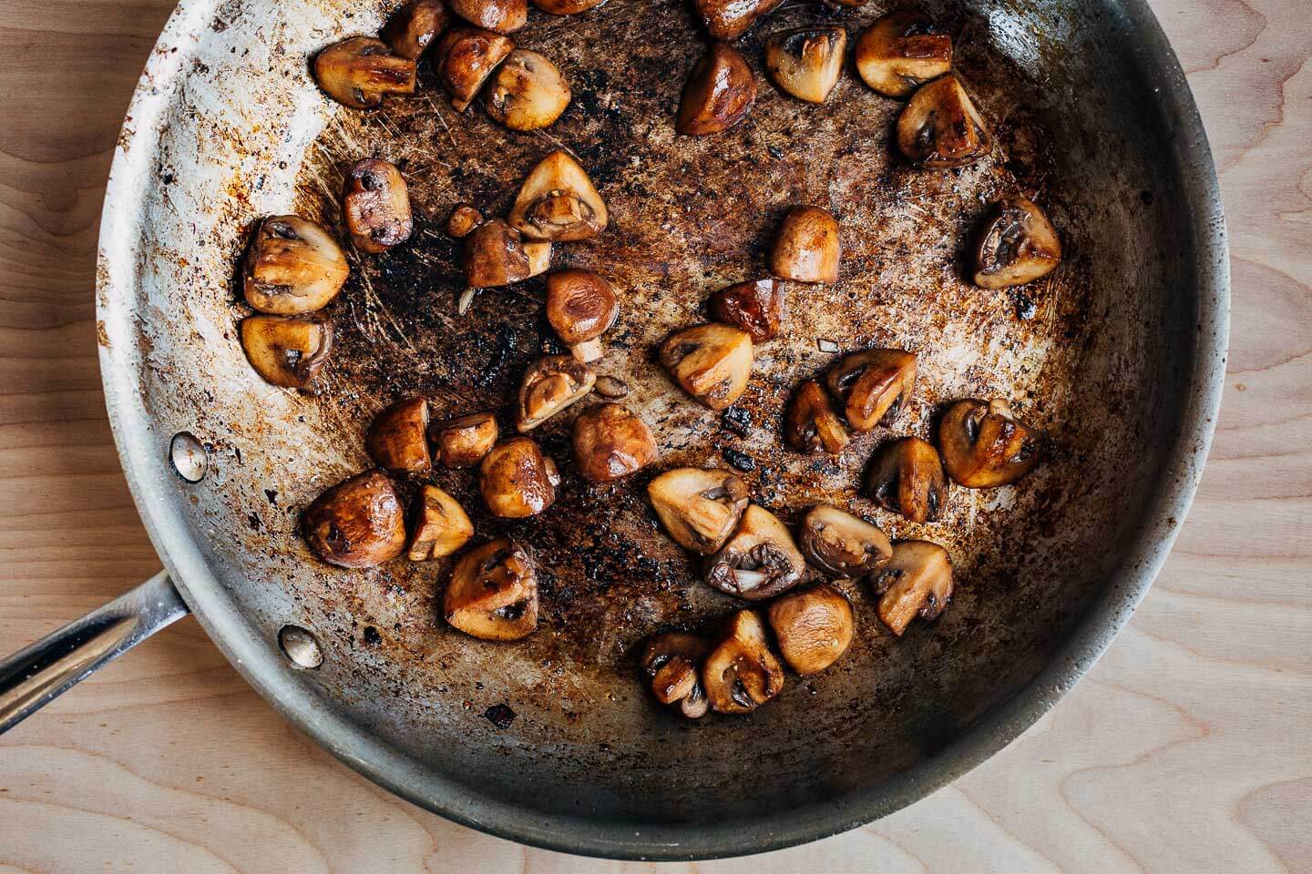 A skillet with sautéed mushrooms. 