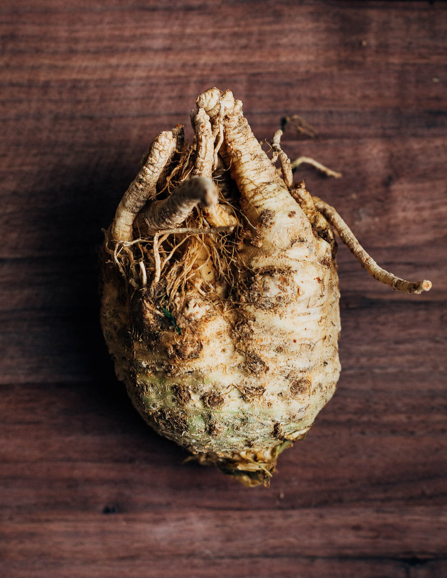 A celery root on a cutting board. 