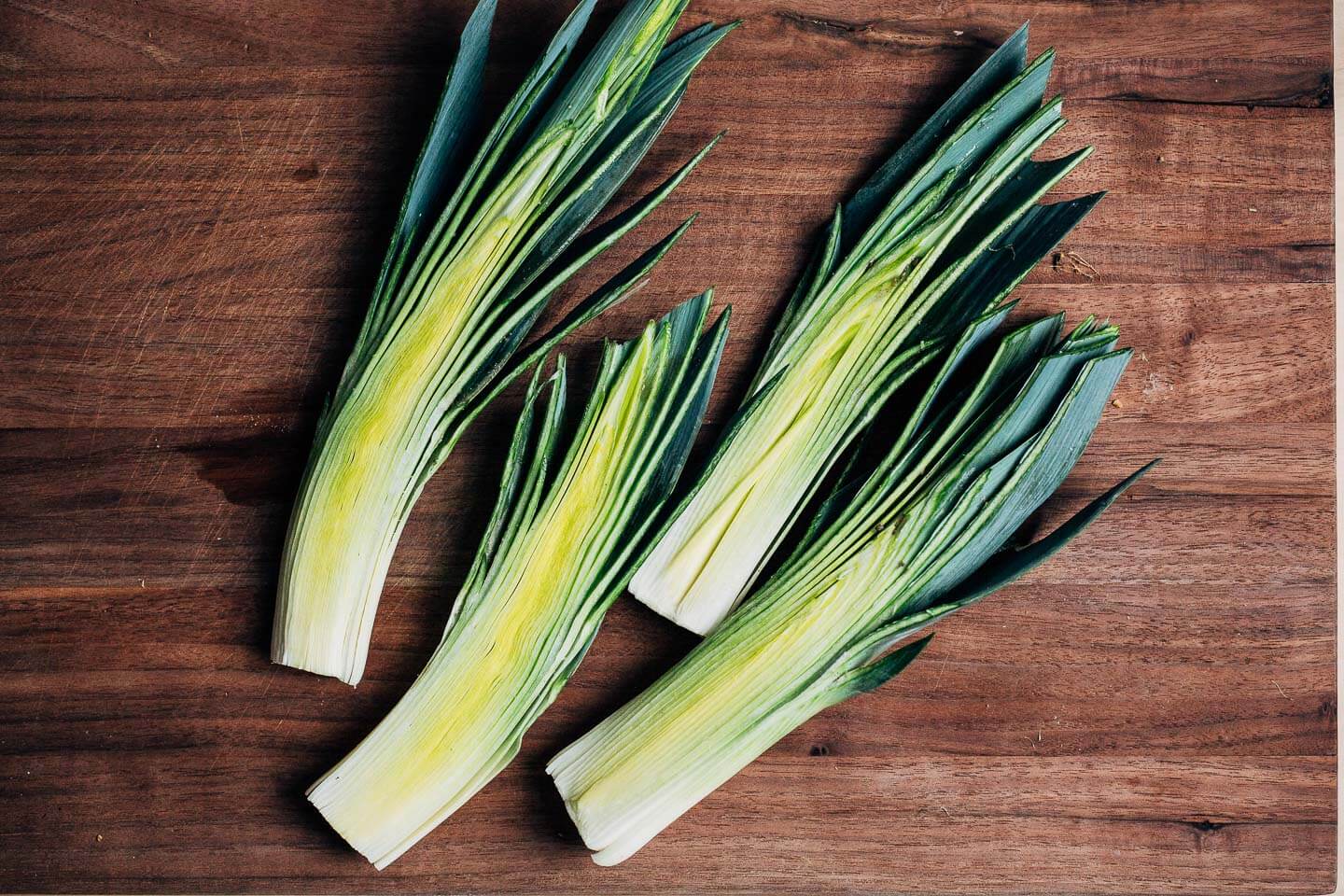 Halved leeks on a cutting board