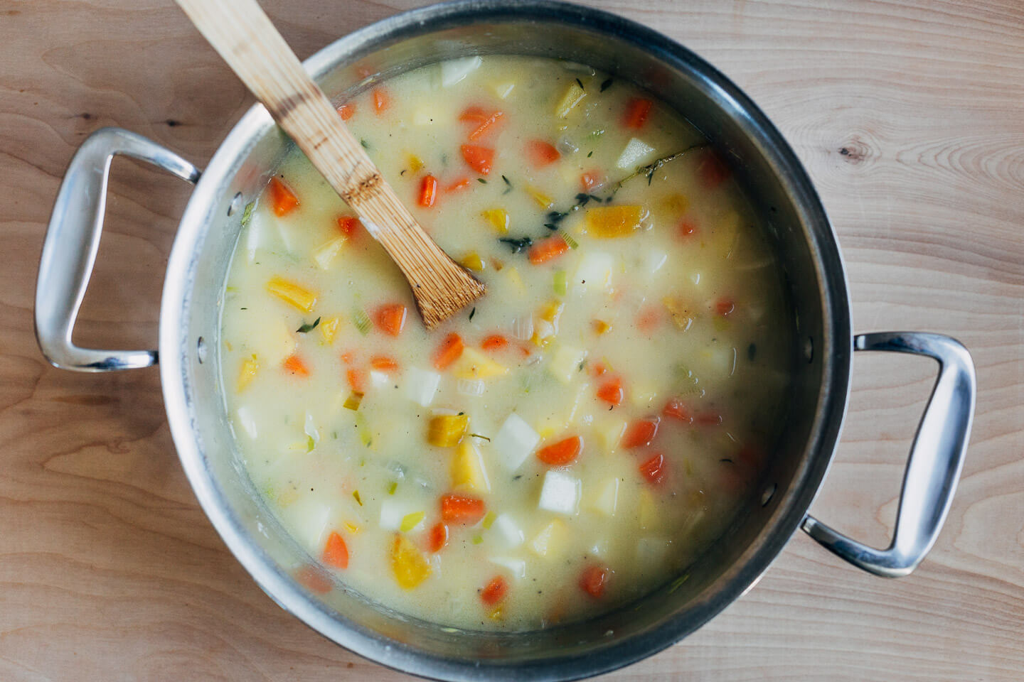 Adding vegetables and chicken to a pot pie filling