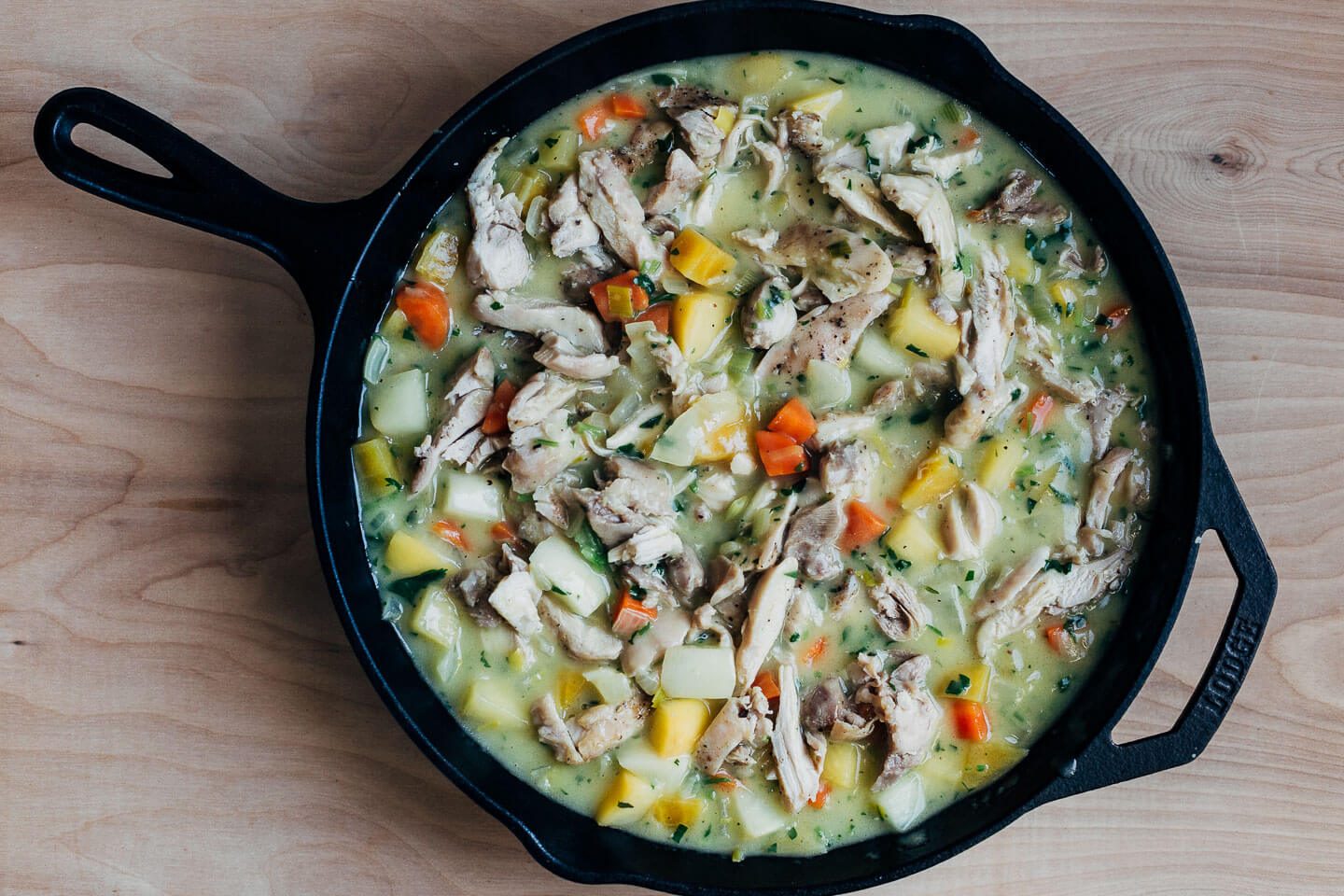Chicken pot pie filling in a skillet
