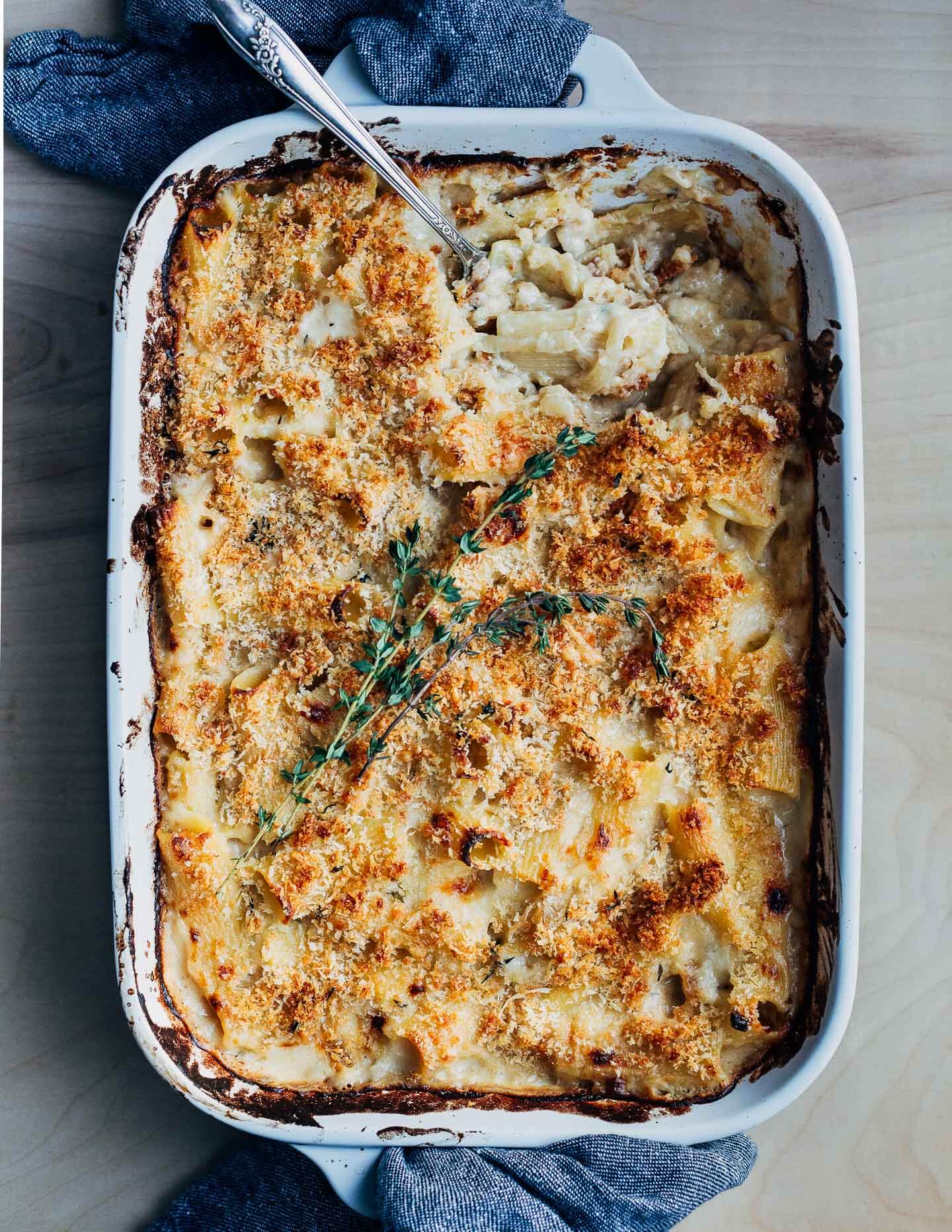 A baking dish with a serving spoon lifting a serving out. 