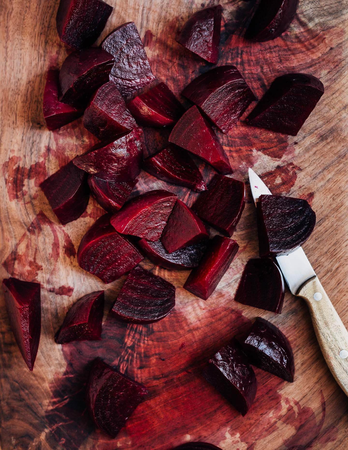 A cutting board with sliced beets.