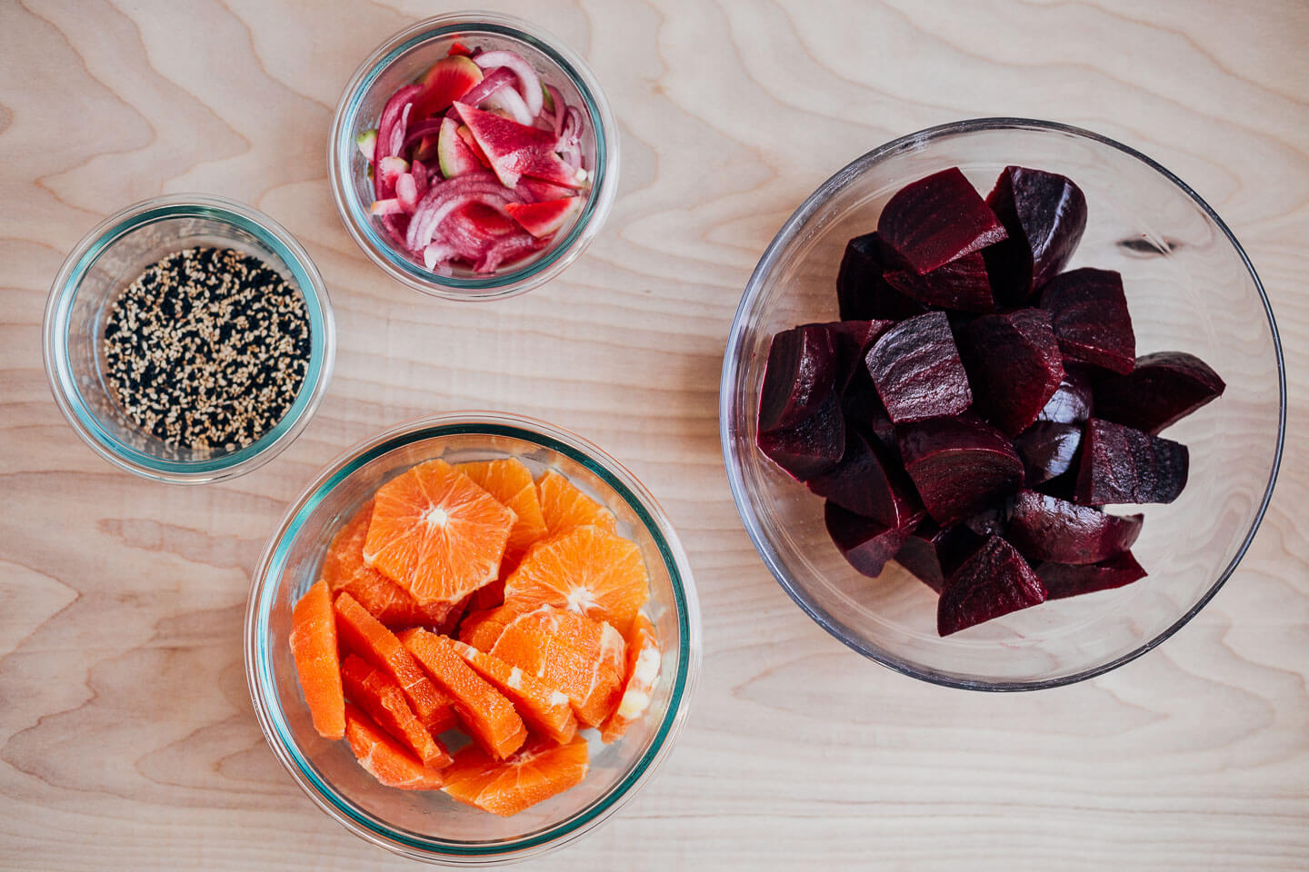 Ingredients for the salad arranged in bowls. 